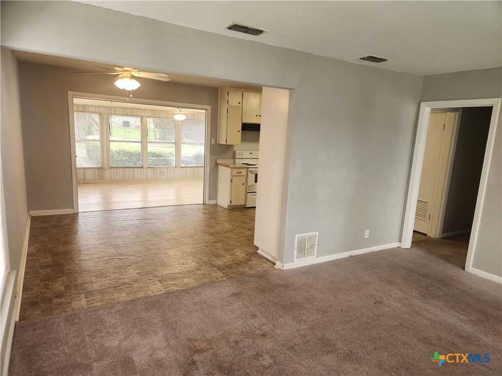 1615 South 15th Street Temple, TX 76504 - Photo 3 of 12 a view of empty room with wooden floor and fan
