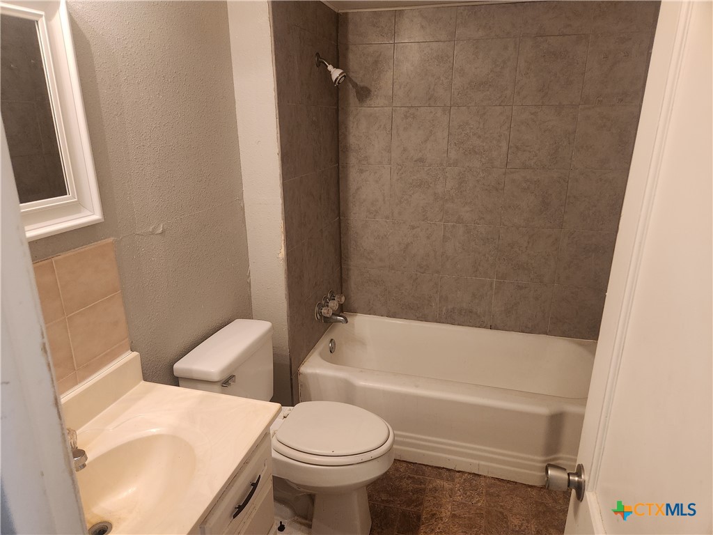 1615 South 15th Street Temple, TX 76504 - Photo 9 of 12 a bathroom with a sink and toilet