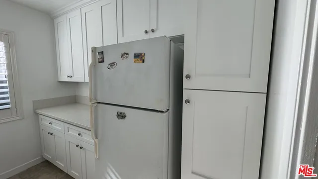 a white refrigerator freezer sitting inside of a kitchen