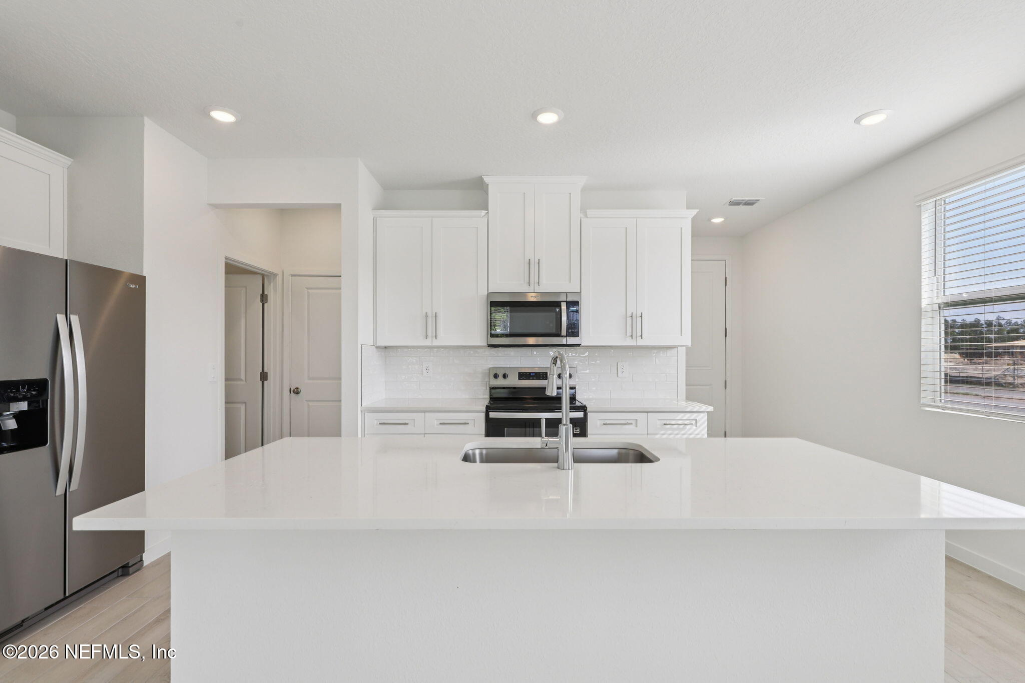 25 Rangeline Drive St. Augustine, FL 32092 - Photo 9 of 43 a kitchen with stainless steel appliances kitchen island sink refrigerator and stove