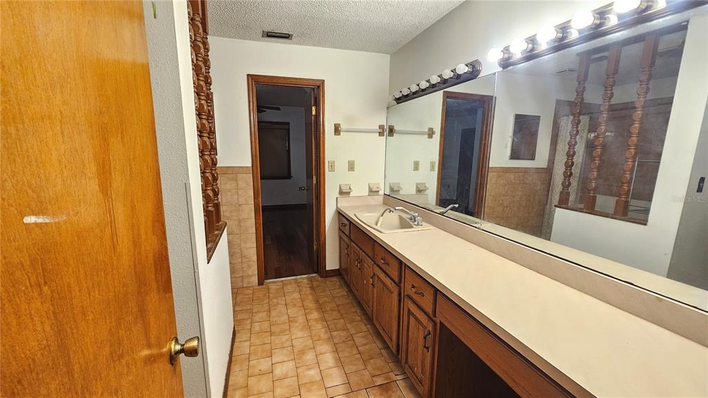 71 Dobson Street Orlando, FL 32805 - Photo 11 of 27 a bathroom with a double vanity sink and a mirror