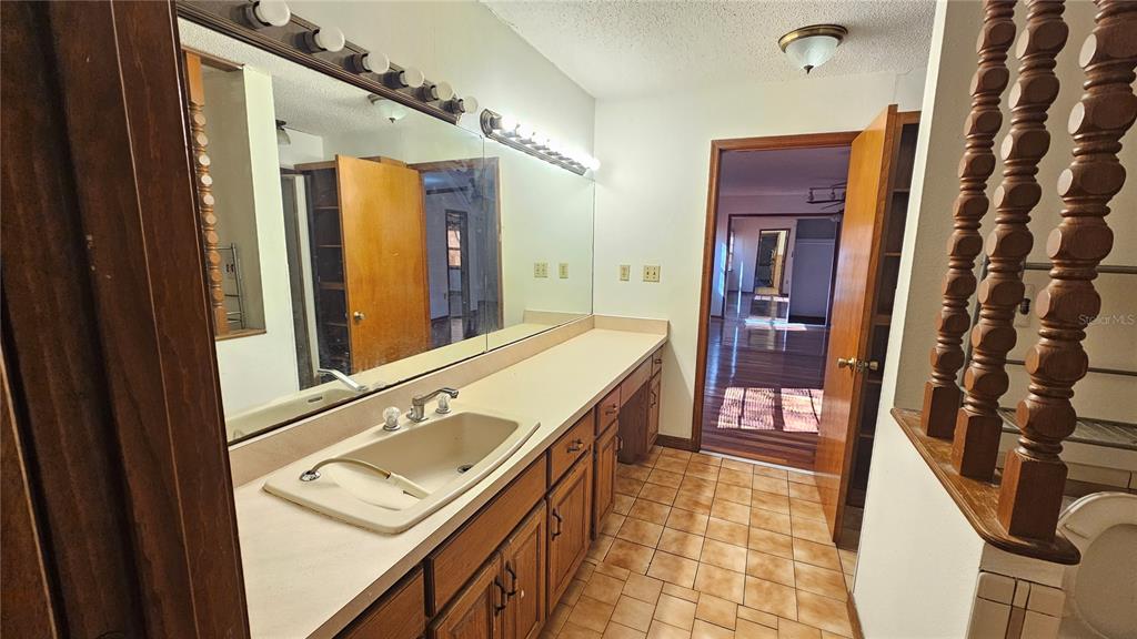 71 Dobson Street Orlando, FL 32805 - Photo 13 of 27 a bathroom with a sink a mirror and a shower