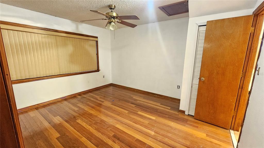 71 Dobson Street Orlando, FL 32805 - Photo 14 of 27 a view of empty room with wooden floor and fan