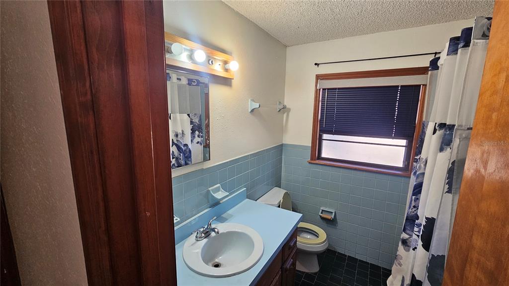 71 Dobson Street Orlando, FL 32805 - Photo 17 of 27 a bathroom with a toilet sink and mirror