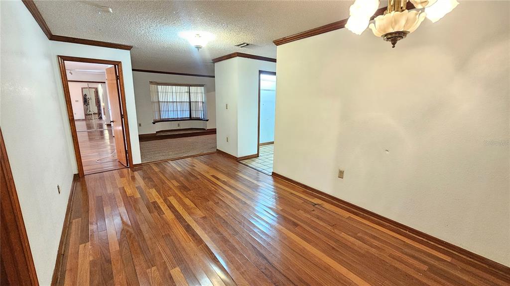 71 Dobson Street Orlando, FL 32805 - Photo 19 of 27 a view of a hallway with wooden floor and staircase