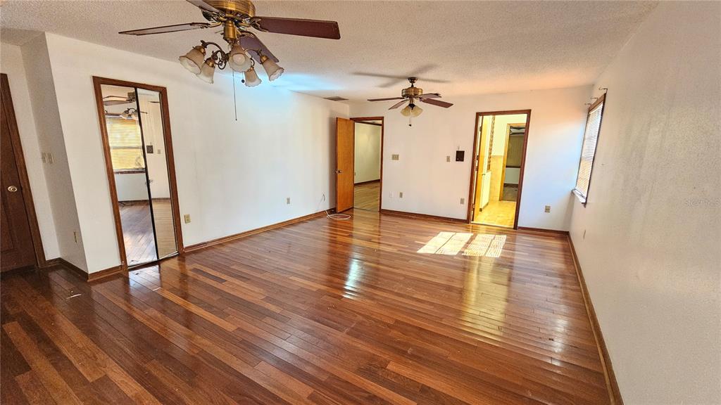 71 Dobson Street Orlando, FL 32805 - Photo 9 of 27 a view of a room with wooden floor and ceiling fan