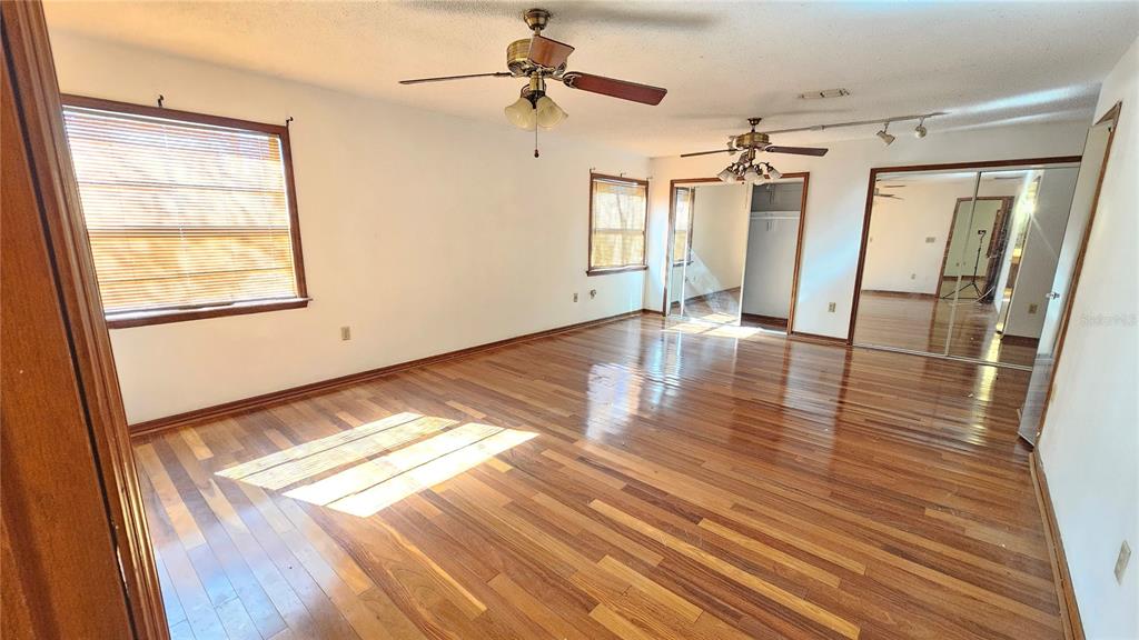 71 Dobson Street Orlando, FL 32805 - Photo 10 of 27 a view of empty room with wooden floor and fan
