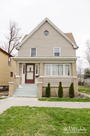 a front view of a house with a garden