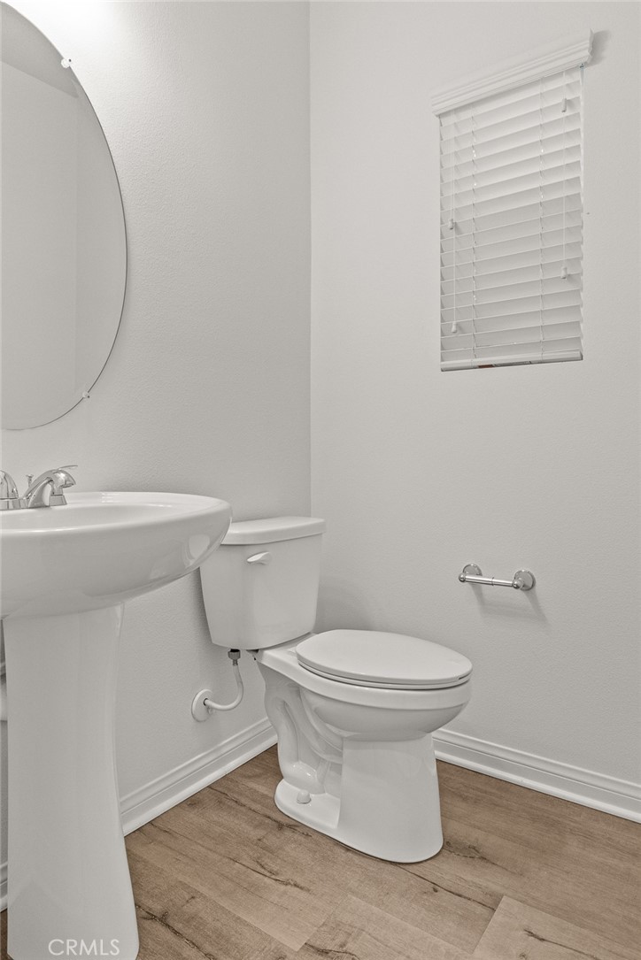 8743 Celebration Street Chino, CA 91708 - Photo 11 of 42 a white toilet sitting next to a bathroom sink