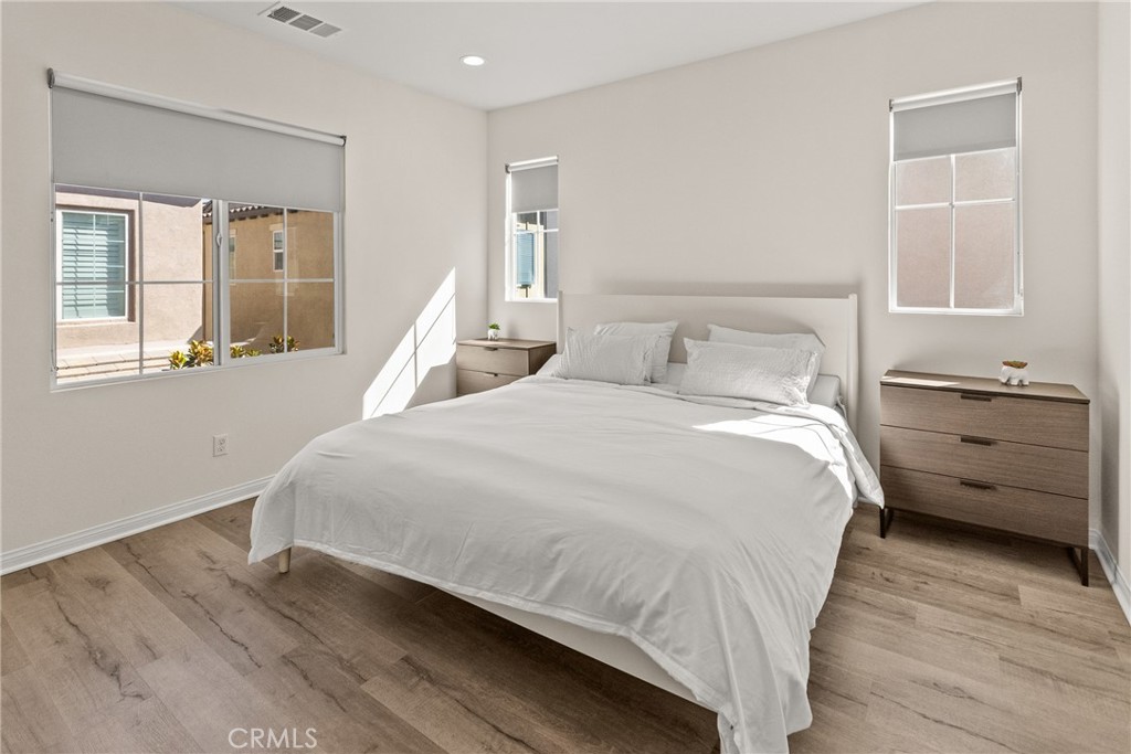 8743 Celebration Street Chino, CA 91708 - Photo 16 of 42 a large bed sitting in a bedroom next to a window and a dresser