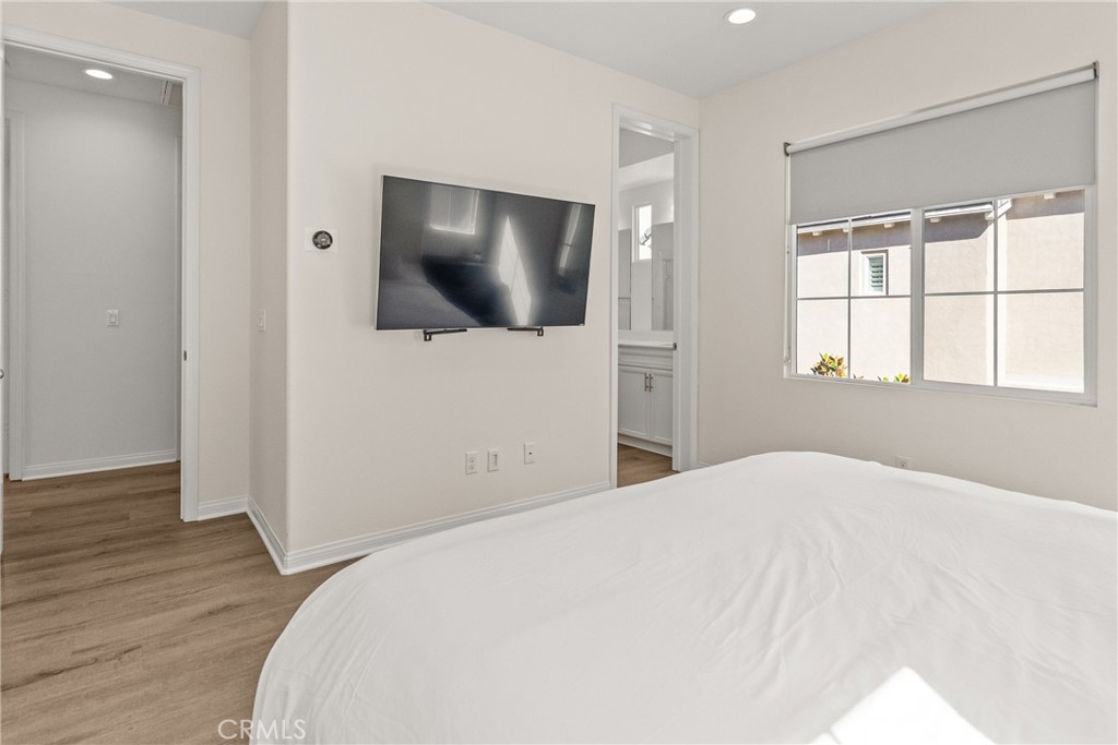 8743 Celebration Street Chino, CA 91708 - Photo 18 of 42 a bedroom with a bed and a flat screen tv