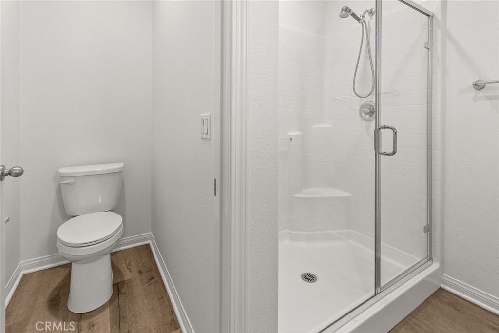 8743 Celebration Street Chino, CA 91708 - Photo 23 of 42 a bathroom with a toilet and a shower