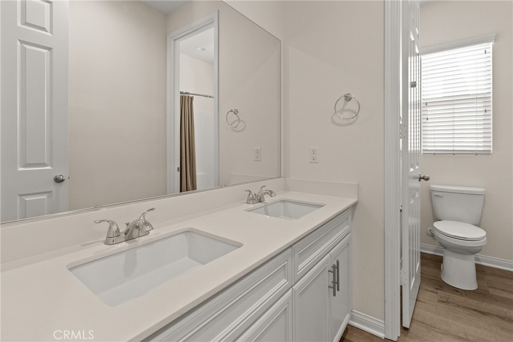 8743 Celebration Street Chino, CA 91708 - Photo 28 of 42 a bathroom with a sink and a toilet