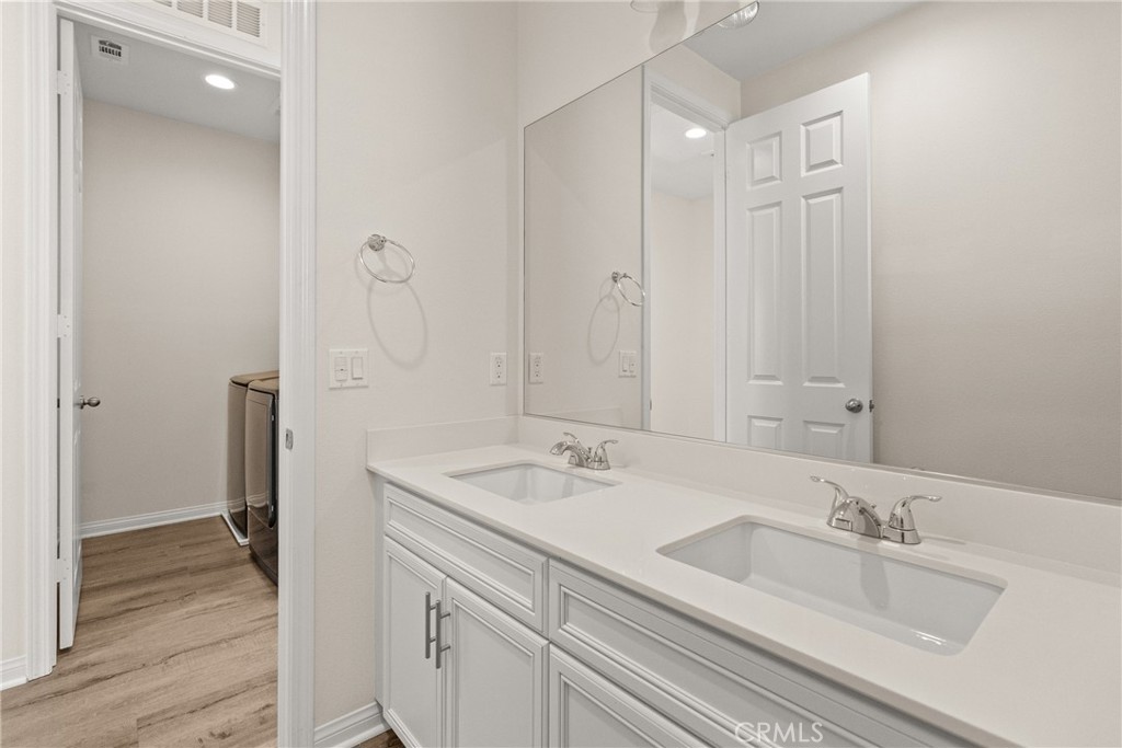 8743 Celebration Street Chino, CA 91708 - Photo 30 of 42 a bathroom with double vanity sink and a mirror
