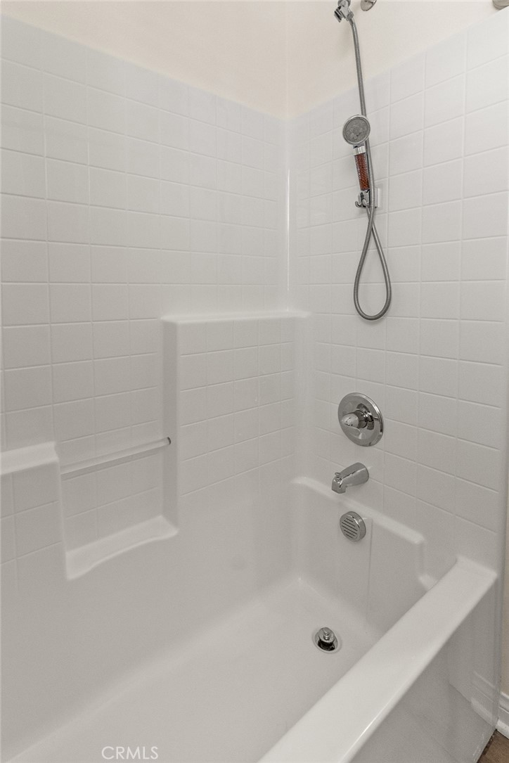 8743 Celebration Street Chino, CA 91708 - Photo 31 of 42 a bathroom with a bath tub with a shower