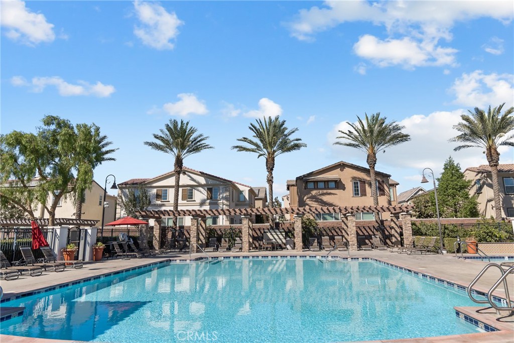8743 Celebration Street Chino, CA 91708 - Photo 41 of 42 a view of a swimming pool with a table and chairs