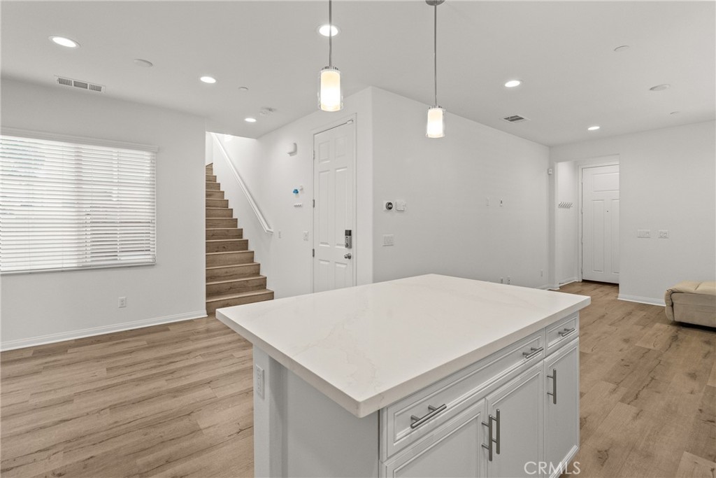 8743 Celebration Street Chino, CA 91708 - Photo 5 of 42 a kitchen that has a cabinets a sink and wooden floor