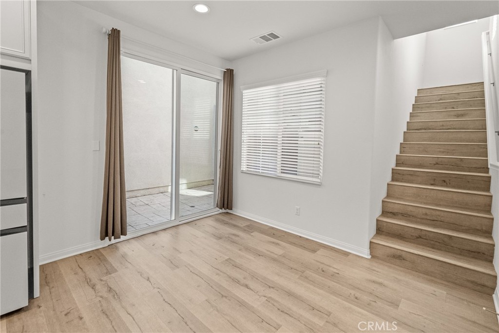 8743 Celebration Street Chino, CA 91708 - Photo 10 of 42 a view of an empty room with wooden floor and windows