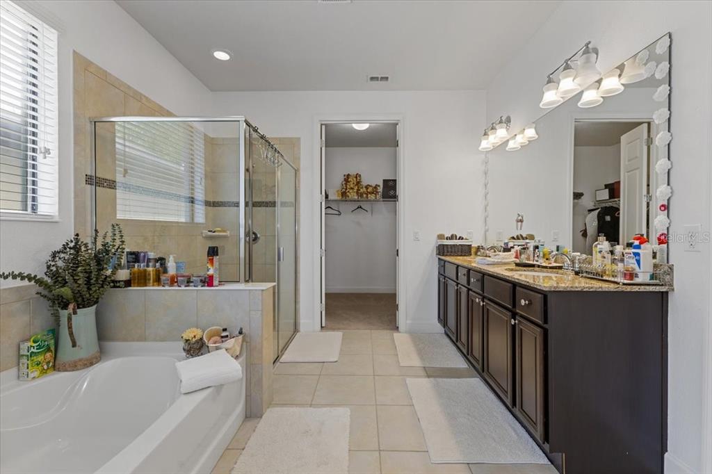 7180 Beek Street Windermere, FL 34786 - Photo 12 of 33 a bathroom with a tub sink and mirror