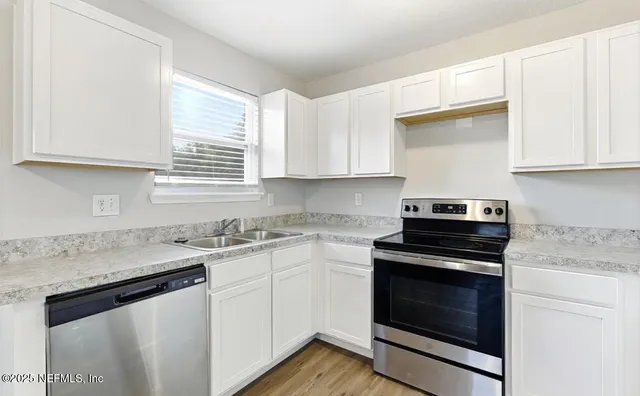 a kitchen with a stove and a sink