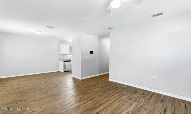 wooden floor in an empty room with a window