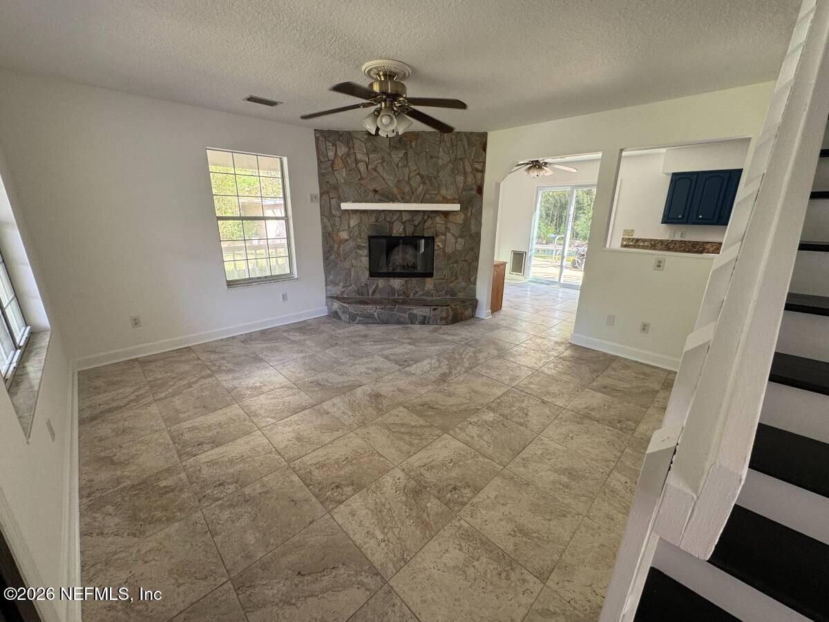 543 Ray Edwards Road St. Augustine, FL 32086 - Photo 2 of 19 a view of an empty room with a fireplace and a window