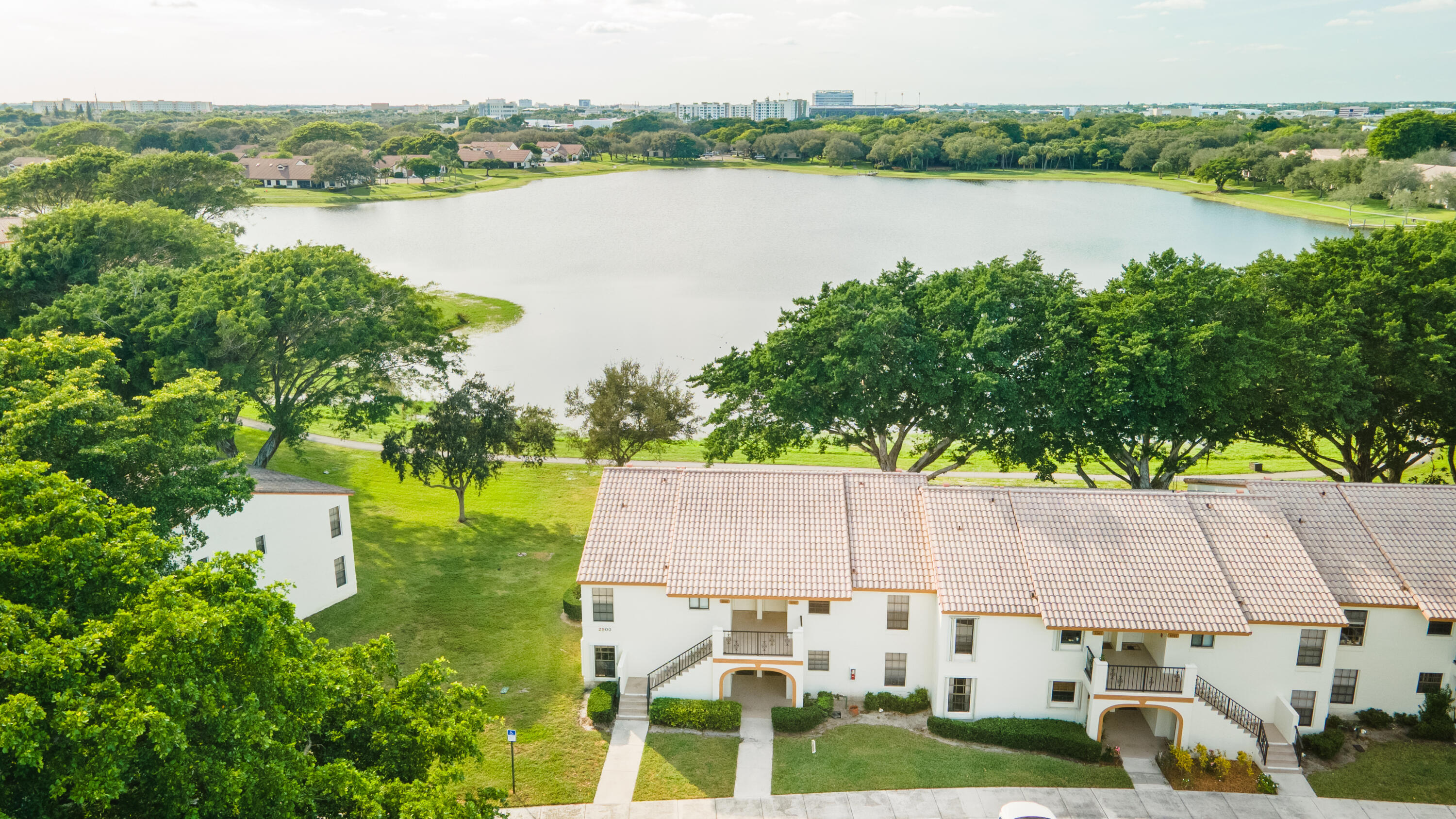 2900 Olivewood Terrace, Unit 2010 Boca Raton, FL 33431 - Photo 19 of 22 a view of a lake with houses in the back