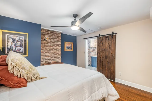 a bedroom with a large bed and a chandelier