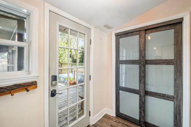 a view of a livingroom with wooden floor and a window