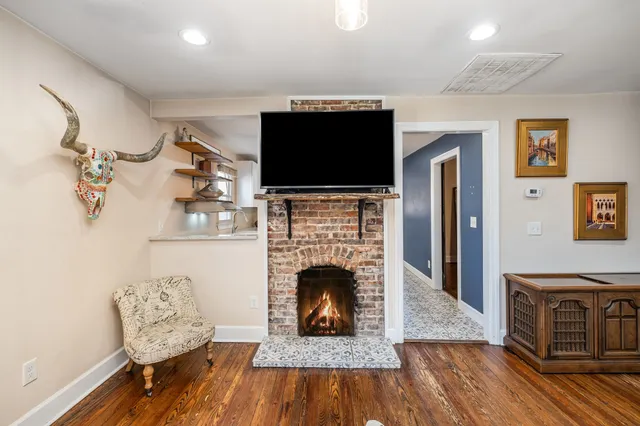 a living room with furniture a flat screen tv and a fireplace