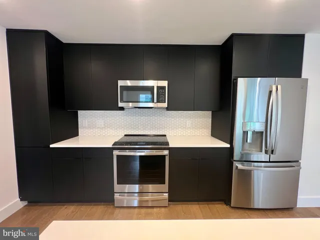 a kitchen with a refrigerator and a stove