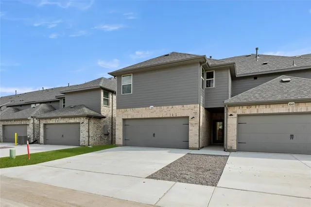 a view of a house with a yard and garage