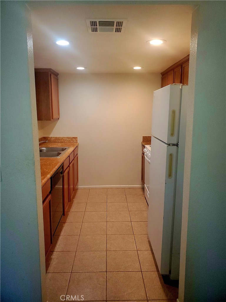 1110 West Blaine Street, Unit 107 Riverside, CA 92507 - Photo 11 of 34 a view of a kitchen with refrigerator and car parked