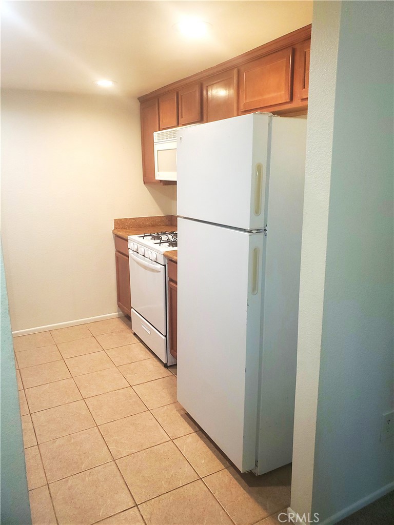 1110 West Blaine Street, Unit 107 Riverside, CA 92507 - Photo 12 of 34 a white refrigerator freezer sitting in a kitchen