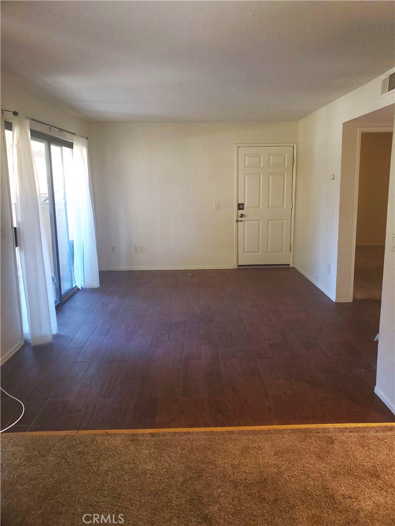1110 West Blaine Street, Unit 107 Riverside, CA 92507 - Photo 6 of 34 an empty room with windows