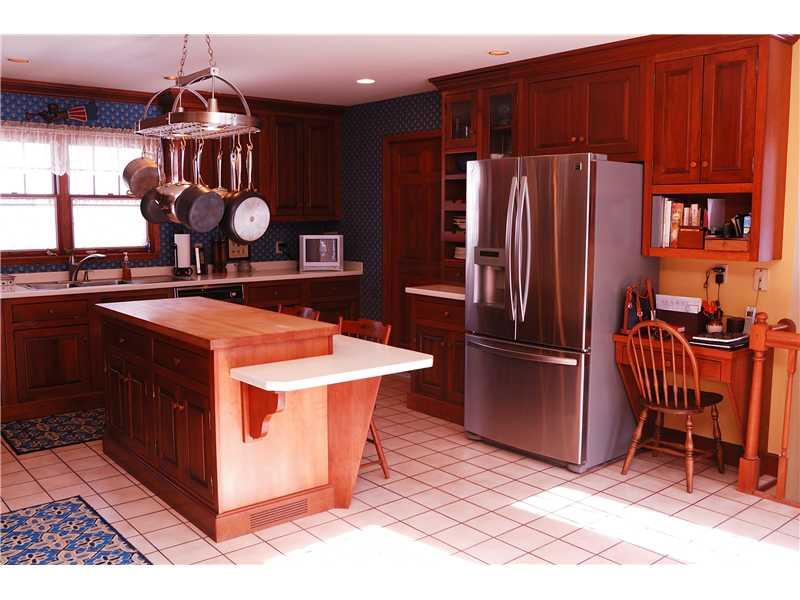 745 Spring Street Harmony, PA 16037 - Photo 12 of 25 Kitchen. A breakfast bar island is perfect for the informal bite to eat and a built-in desk adds convenience!