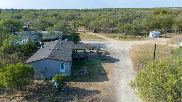 an aerial view of a house with a yard