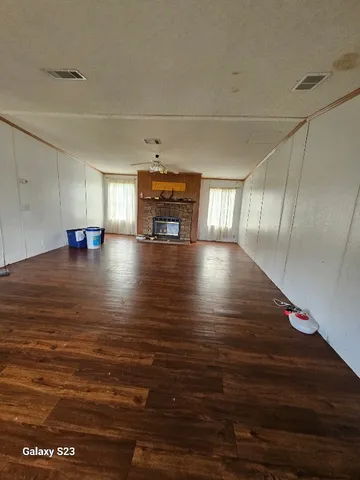 a view of a floor to ceiling window and hardwood floor