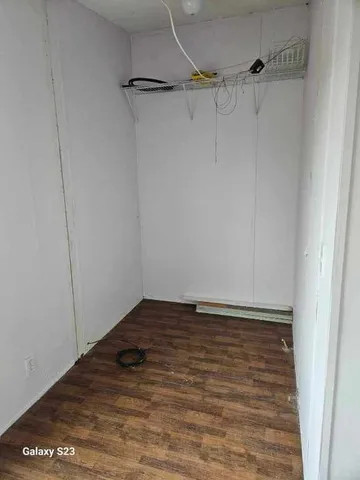 a view of a room with wooden floor