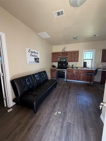 a living room with furniture and a wooden floor