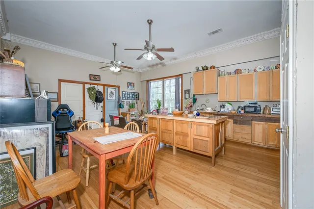 a kitchen with kitchen island granite countertop lots of counter top space and stainless steel appliances