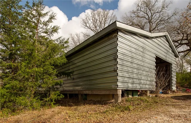 a view of a house with a large window and wooden fence