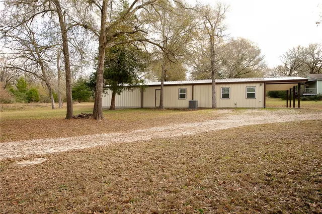 a view of a yard with wooden fence