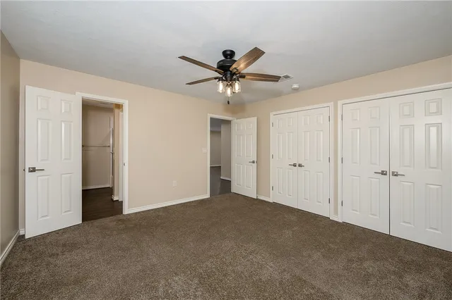 a view of a livingroom with a ceiling fan and window