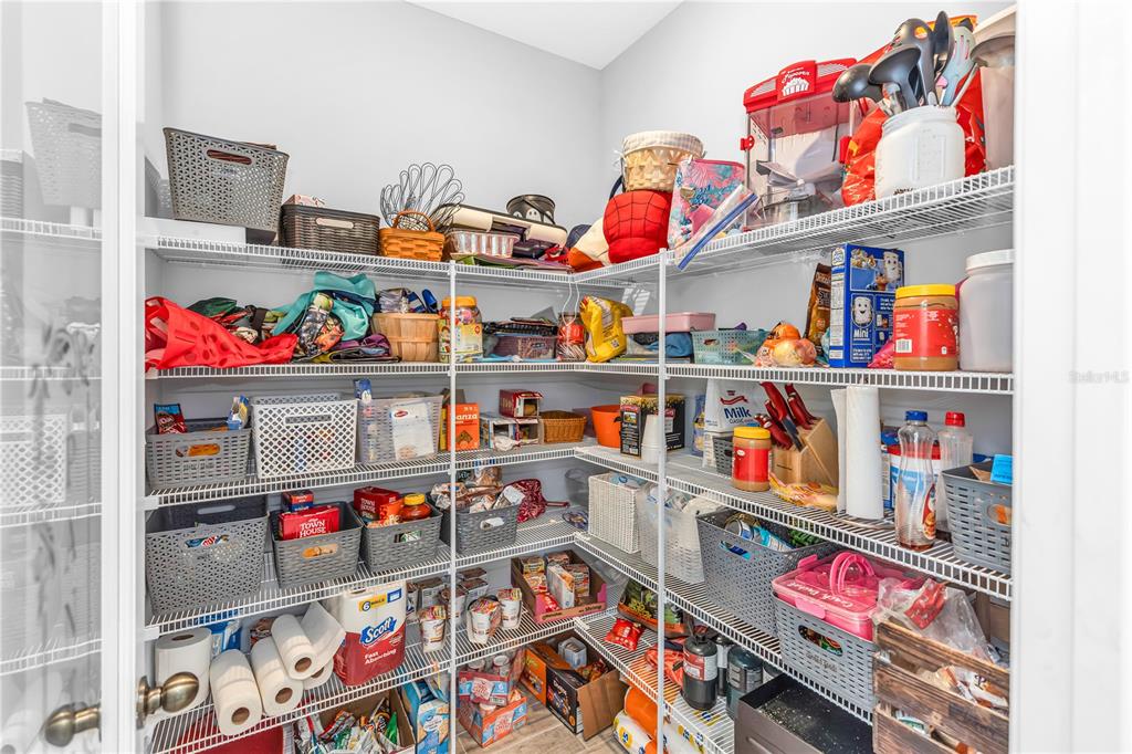 239 Lugano Way DeBary, FL 32713 - Photo 12 of 52 a store room with lots of clutter and storage
