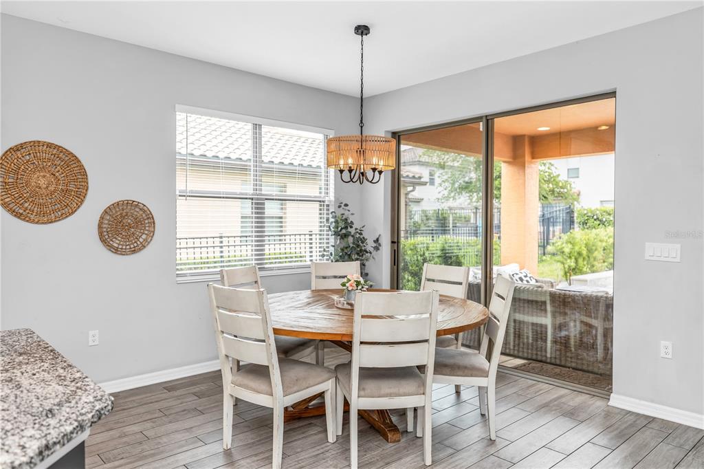 239 Lugano Way DeBary, FL 32713 - Photo 14 of 52 a dining room with furniture a chandelier and wooden floor