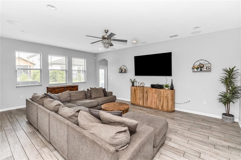 239 Lugano Way DeBary, FL 32713 - Photo 15 of 52 a living room with furniture and a flat screen tv