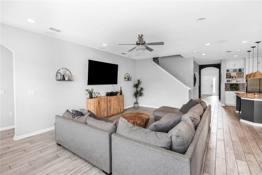 239 Lugano Way DeBary, FL 32713 - Photo 16 of 52 a living room with furniture and a flat screen tv