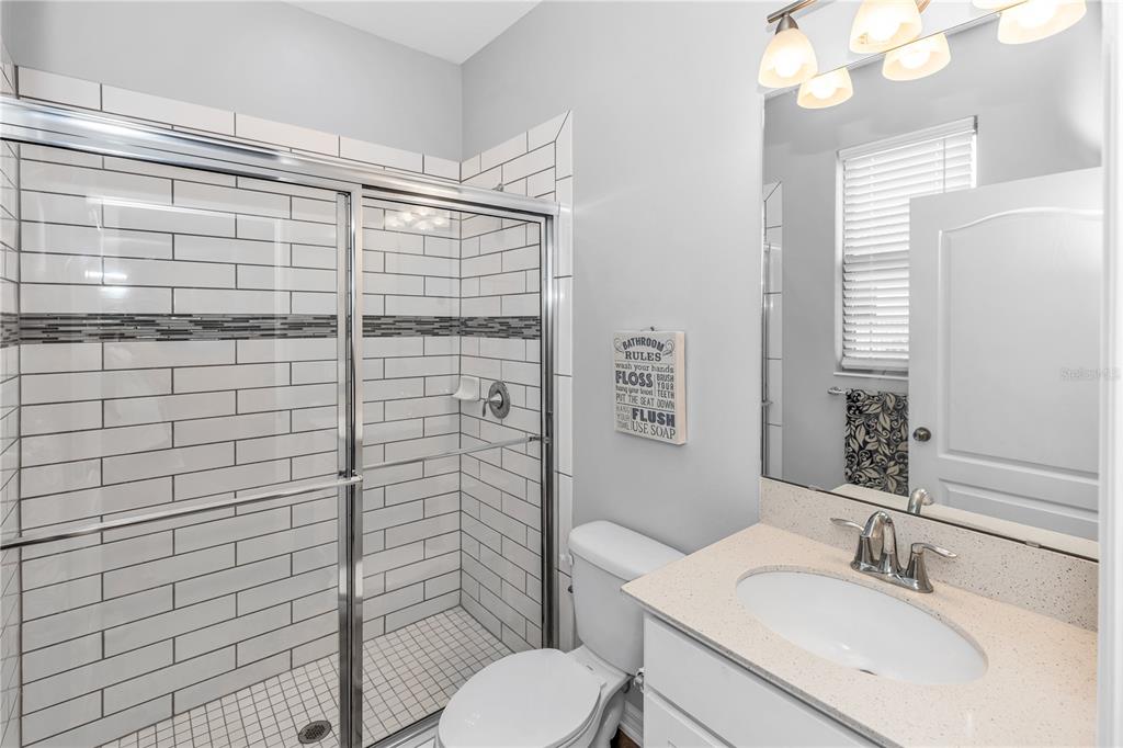 239 Lugano Way DeBary, FL 32713 - Photo 18 of 52 a bathroom with a sink toilet and shower
