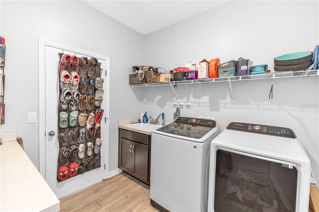 239 Lugano Way DeBary, FL 32713 - Photo 20 of 52 a view of a kitchen with fridge and rack